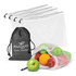 A set of five white mesh produce bags in a black storage pouch, filled with green and red apples and an orange.