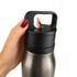 A drink bottle with a sleek, silver body and black cap, being held by a hand. It features a logo.