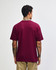 A maroon American Apparel Super Heavyweight T-Shirt displayed from the back, featuring a plain design and a logo.