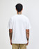 A white American Apparel Super Heavyweight T-Shirt viewed from the back, worn by a model with curly hair.