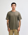 A model wearing an olive green American Apparel super heavyweight T-shirt, with a simple design and no visible logos.