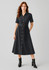 A black midi dress with short sleeves, button detailing, a belted waist, and styled with black ankle boots.