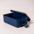 A navy blue lunch box with a wooden lid and a handle, featuring a spacious interior. It has a logo on the side.