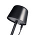 A black mini rechargeable lamp with a curved top and charging cable attached. It features a clean, modern design.