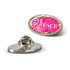 An oval lapel pin featuring a pink and white design with a logo. The pin has a silver back.