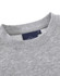 A grey crew fleece jumper with a round neckline and a tag featuring logos.