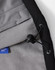 A close-up of a black men's softshell full zip hoodie interior, featuring a grey fleece lining and adjustable drawcord.
