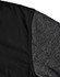A black quilted jacket featuring a heather grey sleeve. Includes a logo on the fabric.