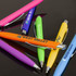 A collection of Javalin pens in various colours: purple, orange, green, blue, and yellow, with branding on some.