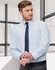 A light blue long sleeve shirt with fine stripes, featuring a chest pocket and paired with a navy tie.