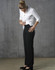 Black low rise pants made from poly/viscose stretch material, paired with a white shirt. The model is adjusting the pants.