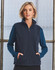 A unisex polar fleece vest in navy, featuring a zip front and side pockets. The model is wearing a long-sleeve top underneath.