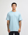 A lightweight, unisex t-shirt in light blue, made from heavyweight cotton, featuring a simple design.