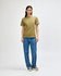 A unisex heavyweight cotton T-shirt in olive green, paired with light blue cargo pants. A logo is present.