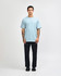 A light blue heavyweight cotton unisex T-shirt worn with baggy denim jeans, featuring a logo on the shirt.