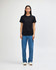 A black heavyweight cotton unisex T-shirt displayed on a model, paired with green cargo pants and sneakers.