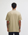 A unisex heavyweight cotton t-shirt in a muted khaki colour, featuring a logo, viewed from the back.