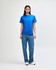 A model wearing a bright blue heavyweight cotton unisex T-shirt paired with light blue jeans.