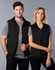 A unisex reversible vest in black, featuring two models wearing it over grey t-shirts. The vest has a zip fastening and a logo.