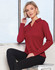 A long sleeve polo shirt in deep red, featuring a collar and a subtle logo. The model poses against a window.