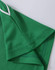 A close-up of a green polo shirt featuring a textured fabric and contrasting collar detail. The shirt has a logo.