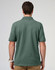 A men's cotton stretch polo in a green hue, featuring a classic polo collar and short sleeves, with a logo.