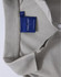A grey Ladies' Truedry Pique Polo with a collar and buttons, featuring a logo tag inside the neckline.