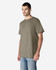 A model wearing an olive green Gildan Ultra Cotton T-Shirt, paired with light blue jeans. The shirt has a logo on it.