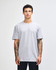 A woman wearing a grey unisex fine jersey short sleeve t-shirt. The shirt features a logo on it.