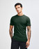 A dark green unisex fine jersey short sleeve T-shirt displayed on a model, featuring a branding logo.