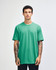 A light turquoise unisex short sleeve t-shirt worn by a model, featuring a logo.
