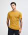 A unisex fine jersey short sleeve t-shirt in mustard yellow, displayed on a model with long hair.