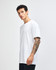 A white unisex fine jersey short sleeve t-shirt displayed on a model from the side. The shirt has a logo.