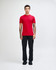 A red unisex fine jersey short sleeve T-shirt displayed on a model adjusting their neck. The shirt has a logo.