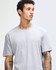 A unisex fine jersey short sleeve T-shirt in grey, paired with black skinny jeans and white sneakers.