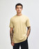 A unisex short sleeve t-shirt in a pale yellow colour, displayed on a model against a plain background.