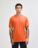 An unisex short sleeve T-shirt in vibrant orange, featuring a simple design and crew neck. It has a logo.