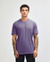 A unisex short sleeve T-shirt in a light purple colour. The shirt features a simple design and has a logo.