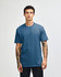 A unisex short sleeve t-shirt in a blue shade, displayed on a model with straight posture. Features a logo.