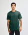 A model displays a unisex short sleeve t-shirt in dark green, featuring a logo on the front.