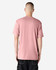 A unisex short sleeve T-shirt in a soft pink colour, featuring a simple design and a visible logo.