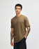A unisex short sleeve t-shirt in khaki, featuring a simple design and a logo on the front.