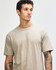 A unisex short sleeve t-shirt in khaki, featuring a relaxed fit and a simple design, with a logo visible.
