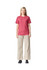 A unisex CVC short sleeve t-shirt in a berry shade, paired with light beige wide-leg trousers. The model stands straight, showcasing the outfit.