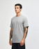 A grey unisex CVC short sleeve t-shirt displayed on a model. The shirt has a simple design and features a logo.