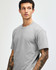 A grey unisex CVC short sleeve T-shirt displayed on a model with a plain background. It features a subtle logo.