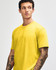 A unisex short sleeve T-shirt in bright yellow with a casual fit. The T-shirt features a logo on it.