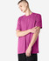 A unisex short sleeve t-shirt in a vibrant magenta colour, worn by a model with a neutral expression.