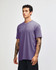 A unisex CVC short sleeve t-shirt in purple, featuring a simple design and a fitted cut.