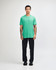 A unisex short sleeve t-shirt in vibrant green, paired with black cargo pants and styled on a male model.
